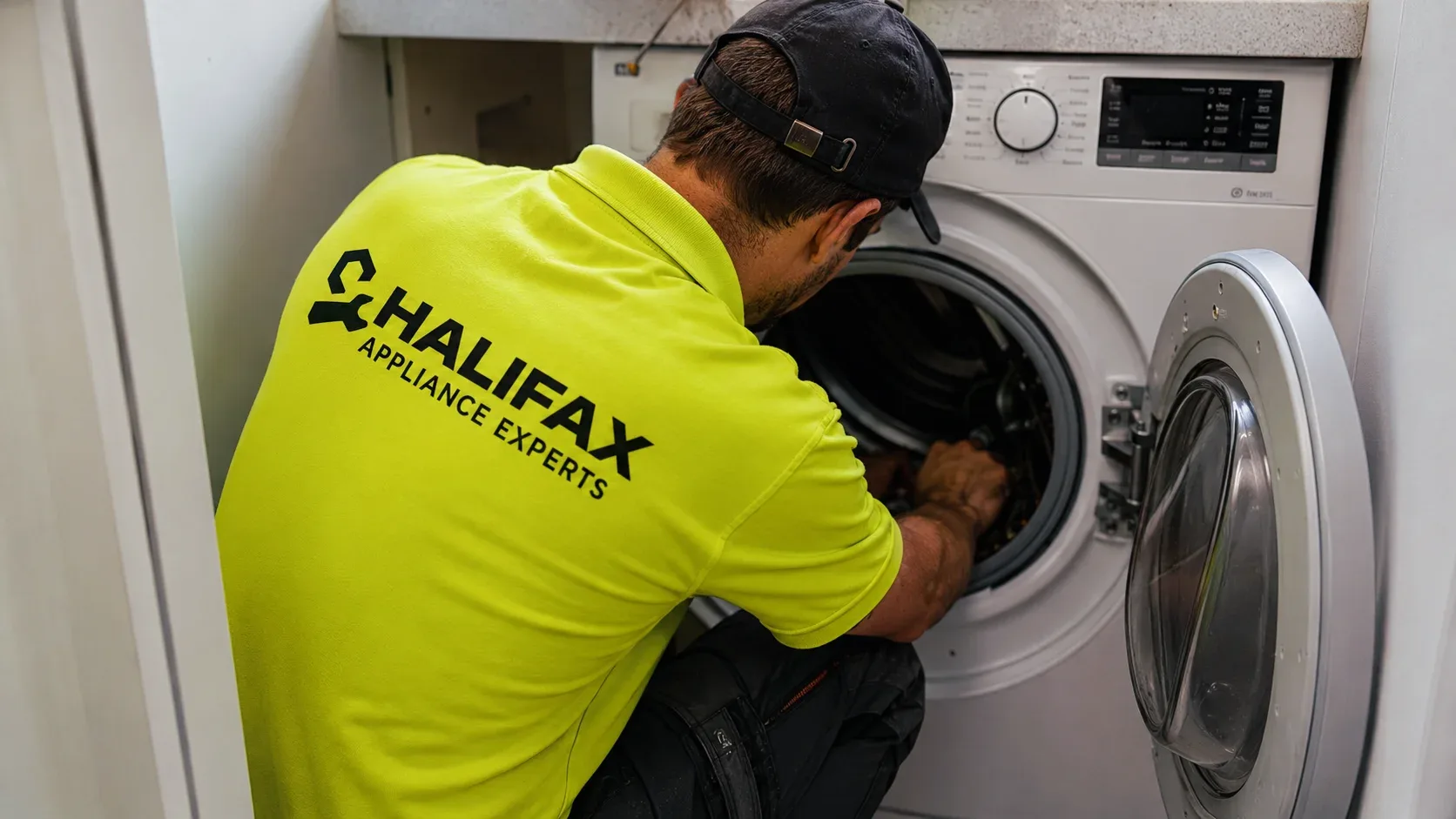Appliance repair technician at work